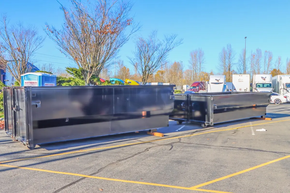 Professional dumpster rental service with roll-off container on residential driveway in Eden Prairie